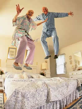 seniors jumping on bed