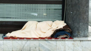 homeless woman in blanket