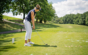 woman golfer about to tee off